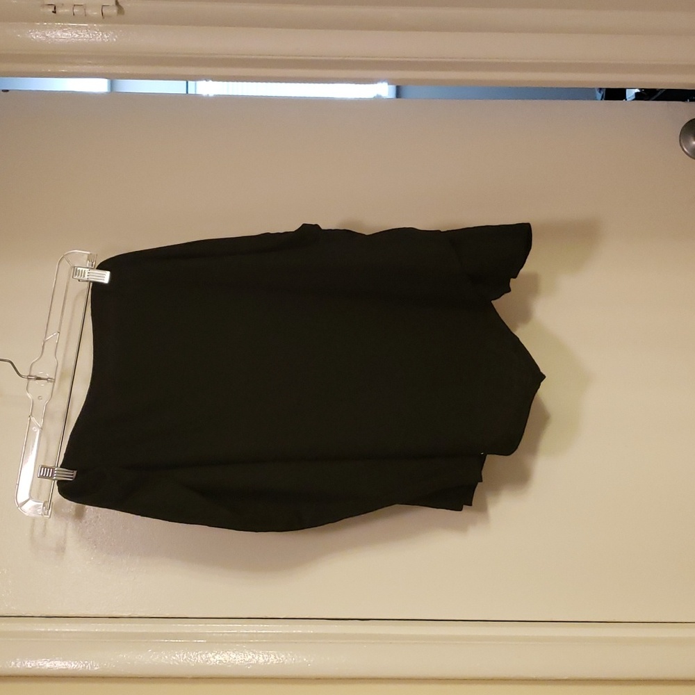 Black skirt. Roughed on left side with asymmetric hem